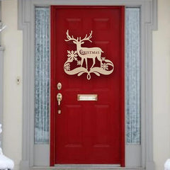 Red door with a Christmas reindeer decoration on a snowy day
