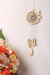 Wooden dreamcatcher with feathers and flowers on a white background