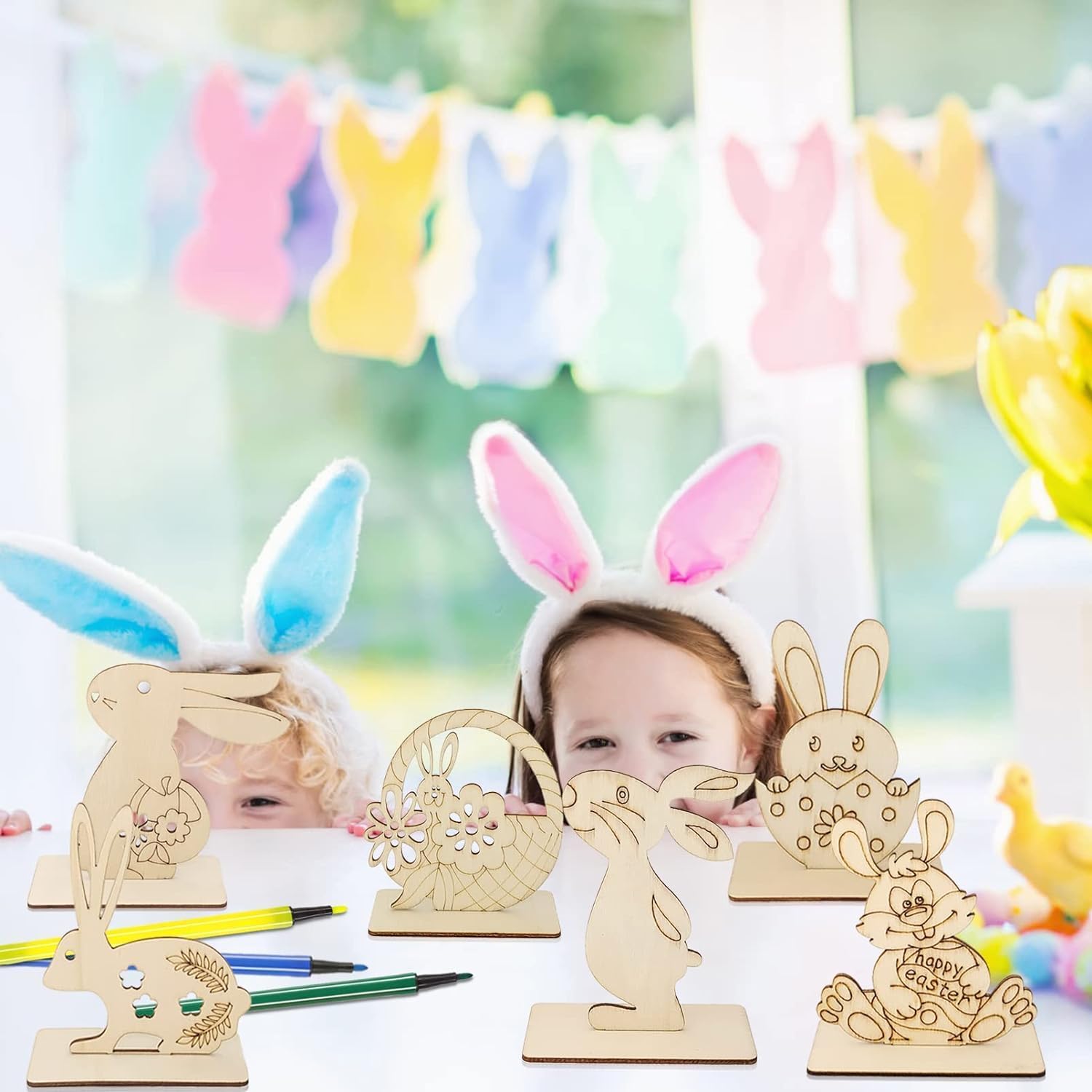 Children wearing bunny ears with wooden Easter decorations in a festive setting.