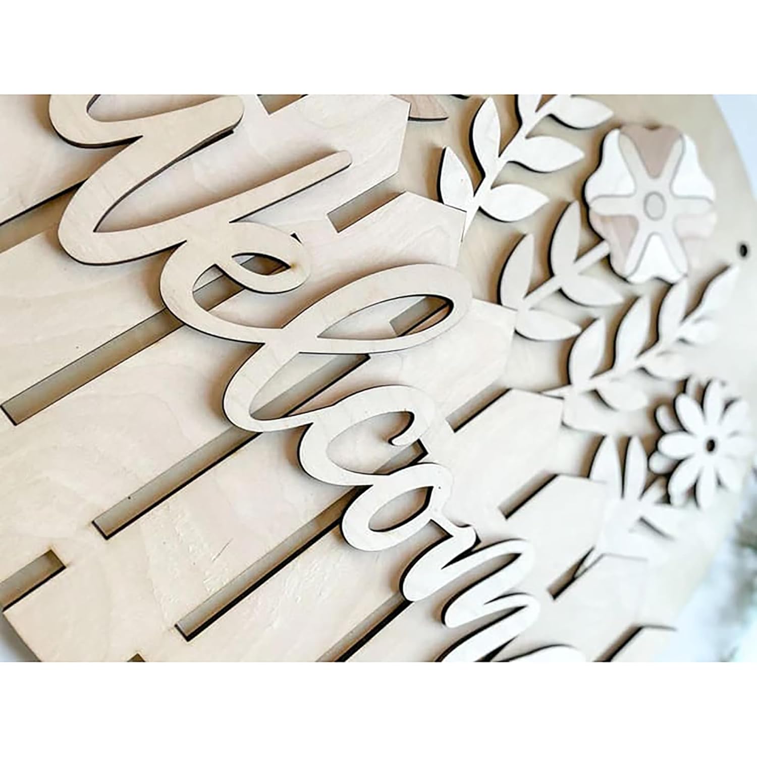 Wooden letters and floral shapes on a white background