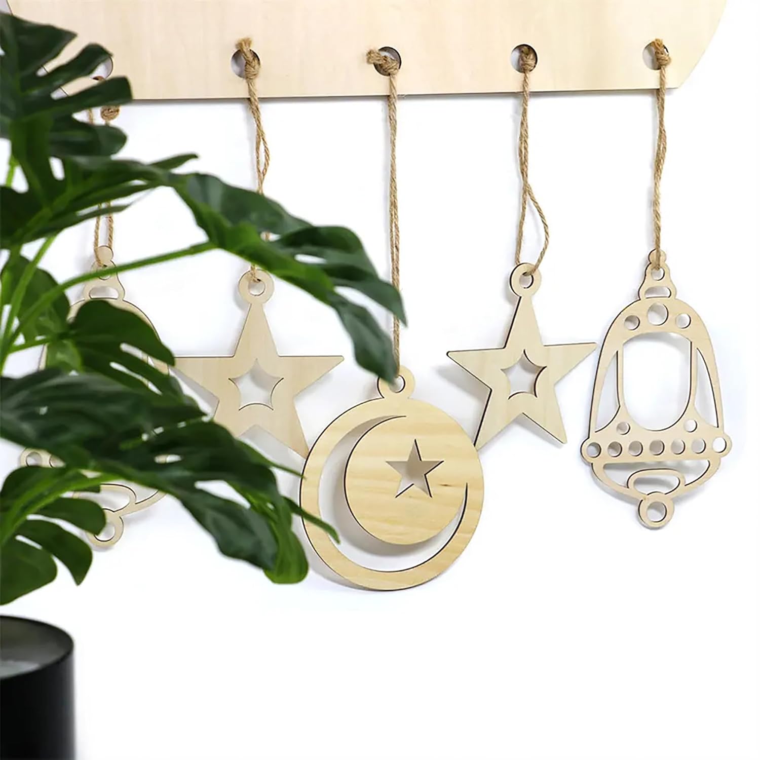 Decorative hanging ornaments with star and moon designs on a white background.