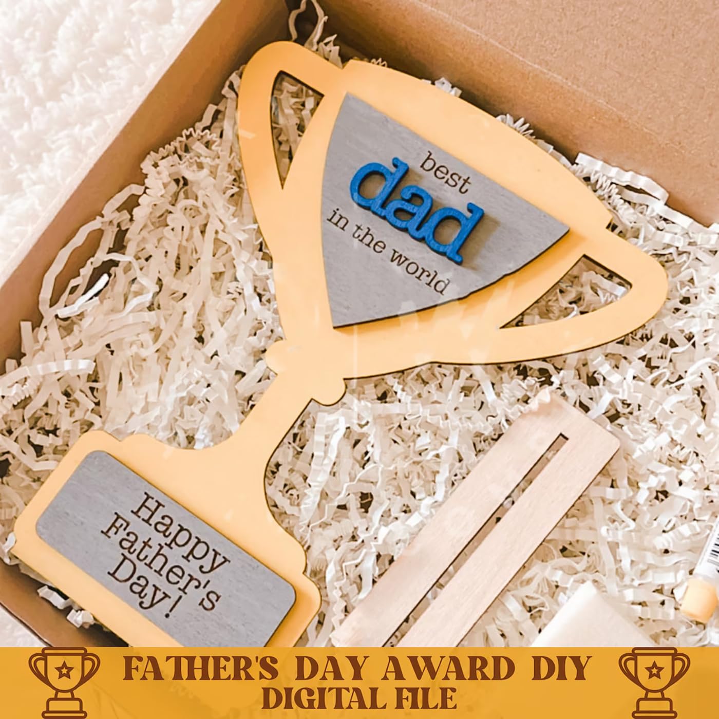 Wooden axe-shaped bottle opener with 'best dad in the world' and 'Happy Father's Day!' text, placed in a box with shredded paper.
