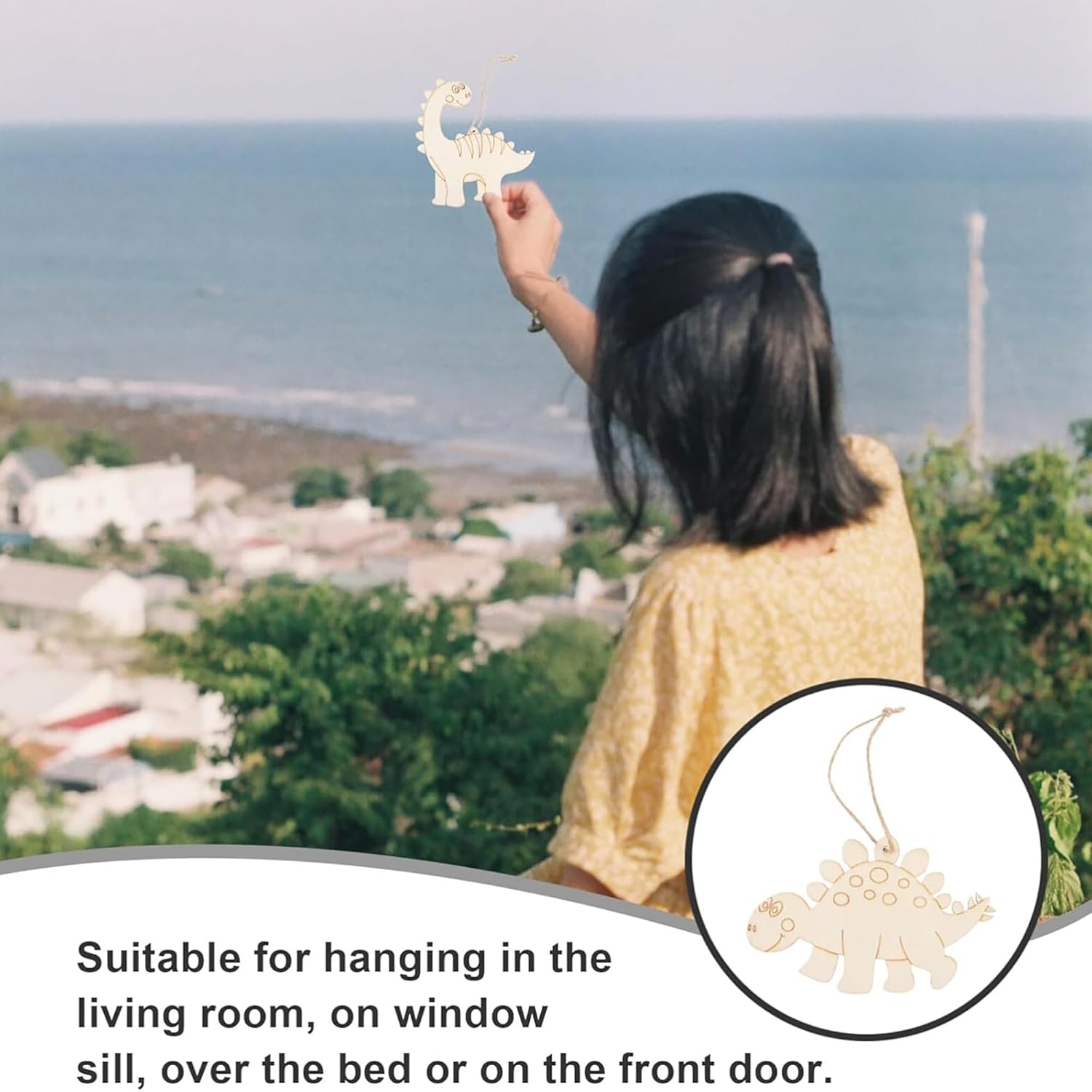 Person holding a small dinosaur ornament with scenic background