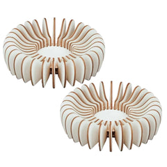 Two wooden coasters with a unique spiral design on a white background