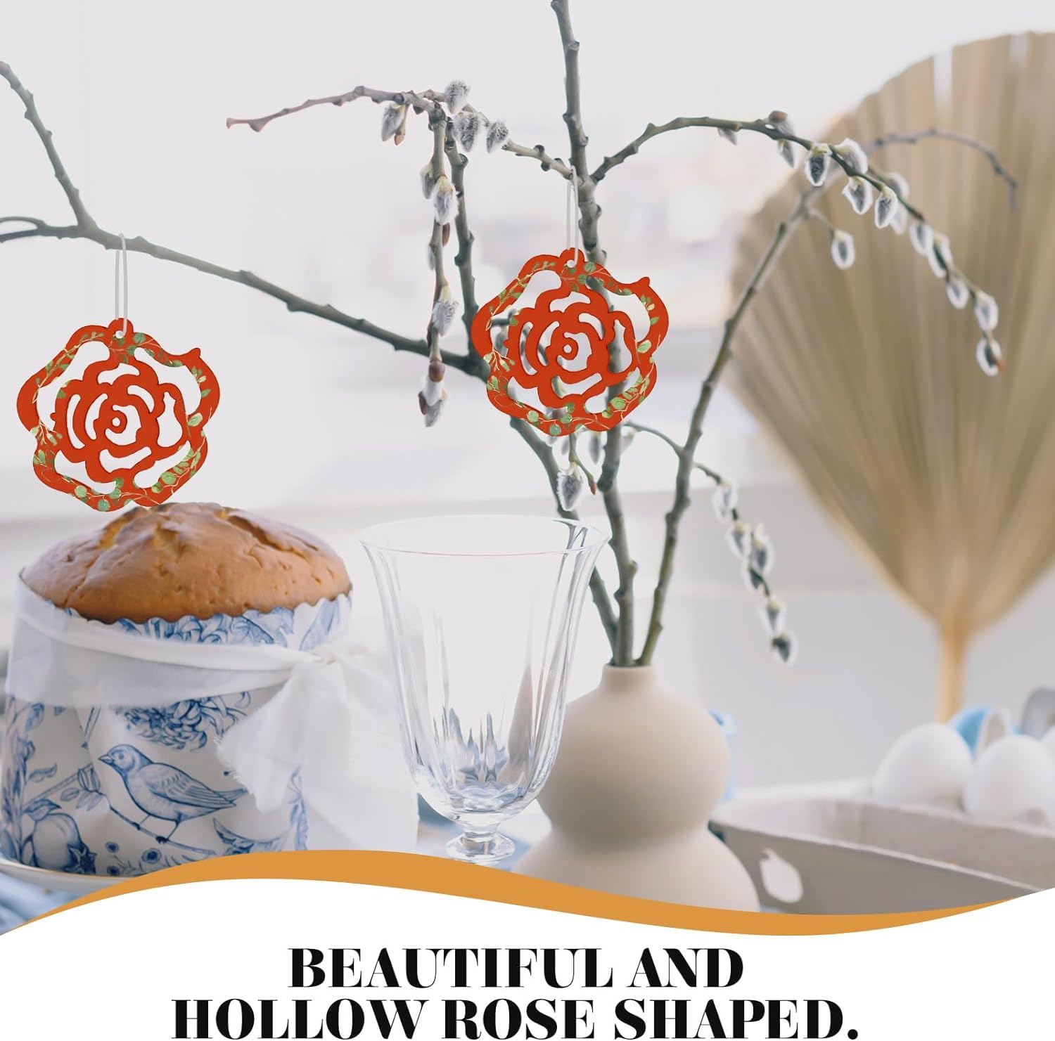 Decorative rose-shaped items hanging from branches with a blurred background.