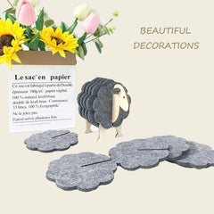 Decorative sheep-shaped card with cloud cutouts on a light background, accompanied by flowers.