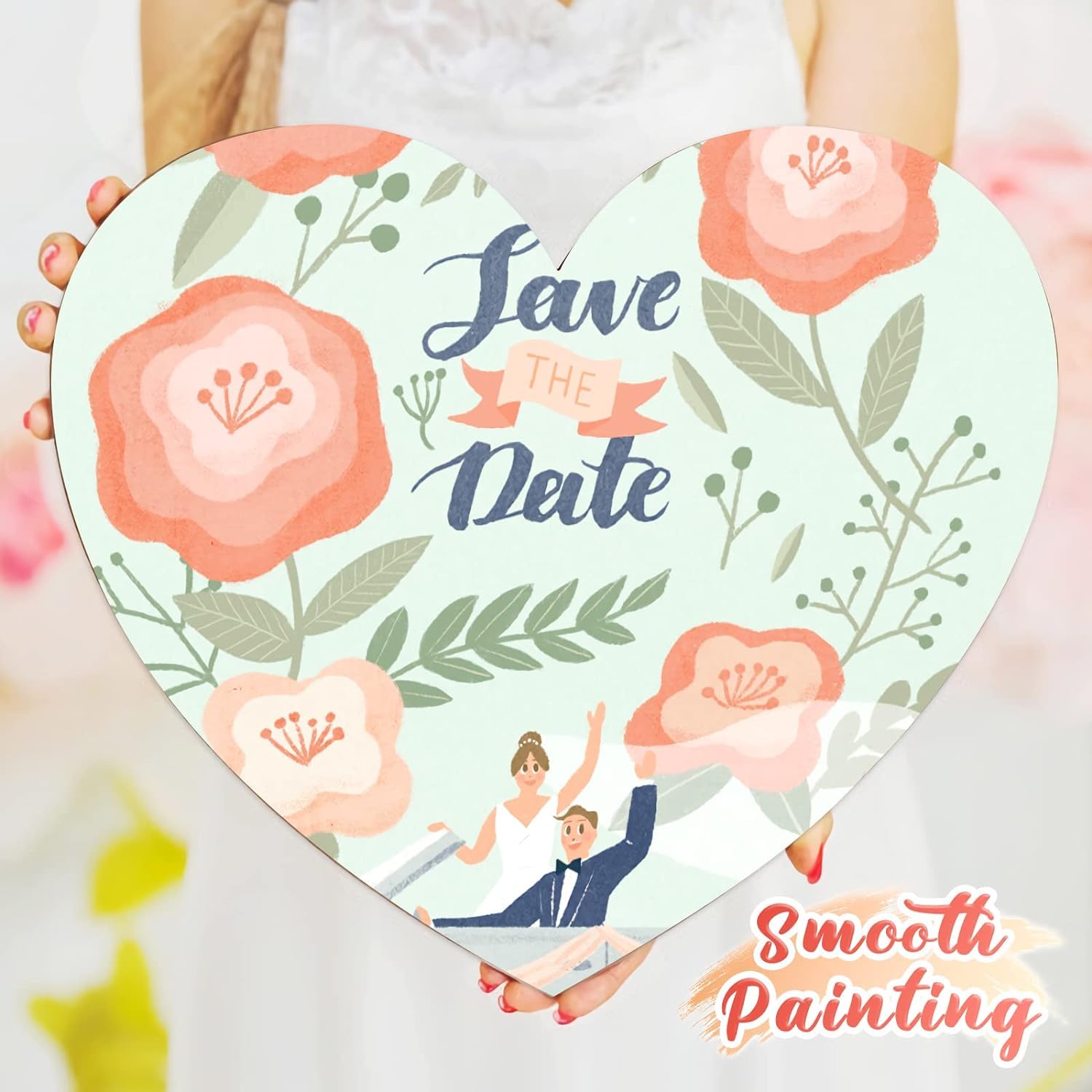 Heart-shaped card with floral design and 'Save the Date' text, held by a person.