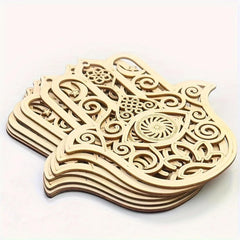 Stack of wooden Hamsa hand decor items with intricate carvings on a white background