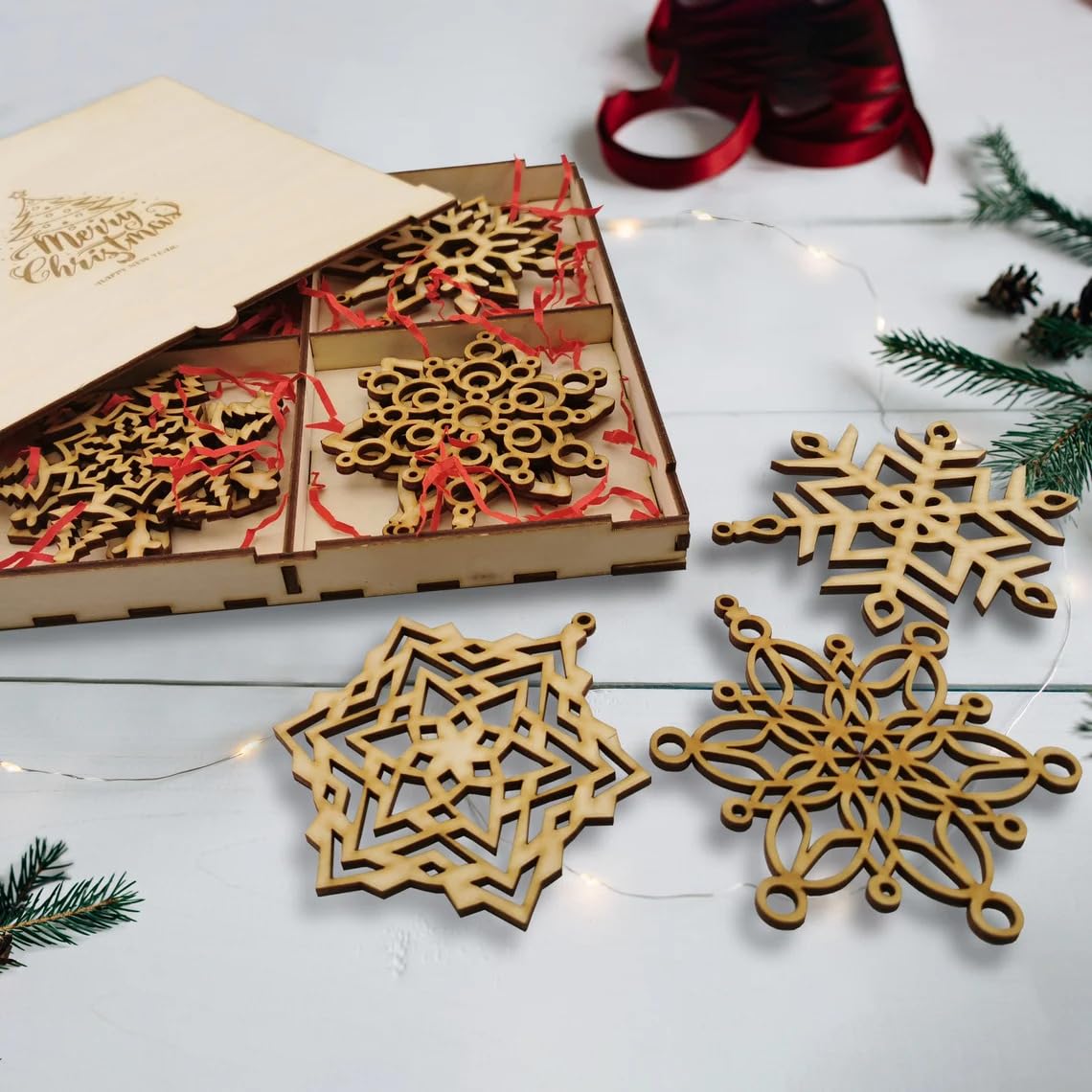 Wooden snowflake ornaments with packaging on a white surface with Christmas decorations.