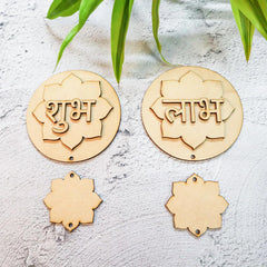 Wooden lotus-shaped decorations with engraved text on a textured surface with green leaves.