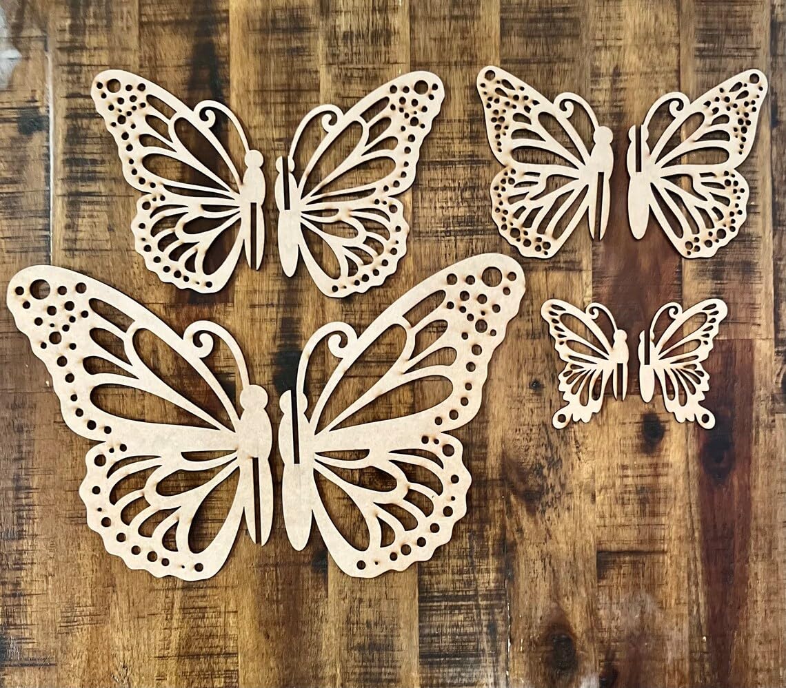 Four decorative butterfly shapes on a wooden surface