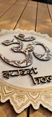 Decorative wooden sign with 'Om' symbol and '30 sweet hols' text on a wooden surface