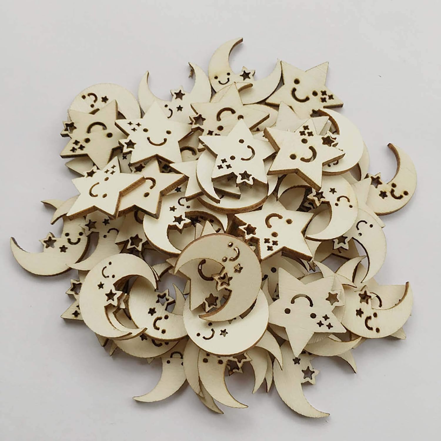 Wooden moon and star shapes with smiling faces on a light gray background