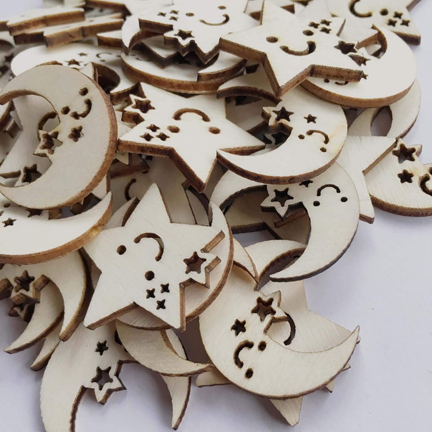 Wooden moon and star shapes on a white background