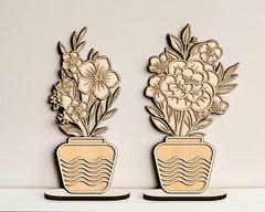 Two decorative wooden planters with floral designs on a light background