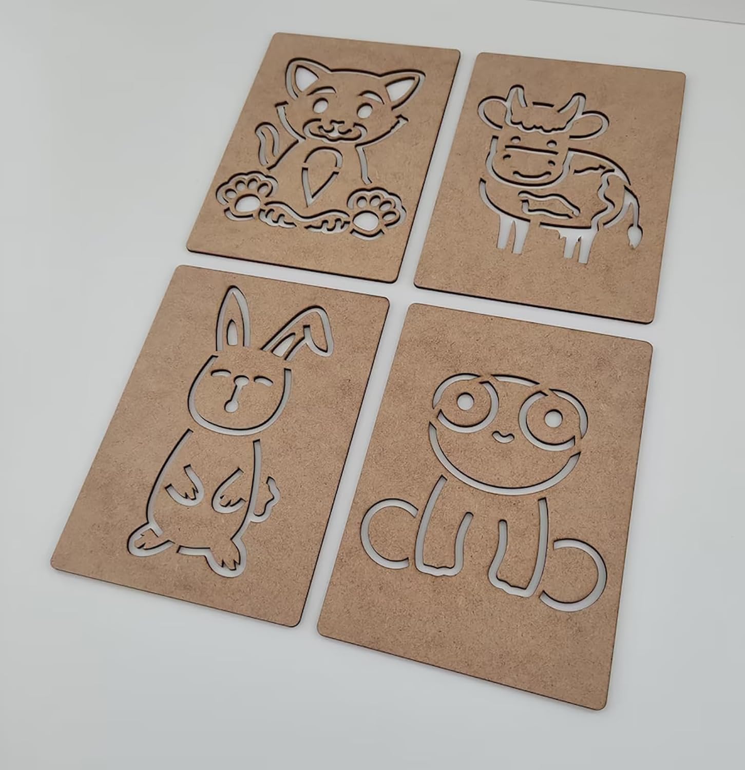 Four cardboard cutouts of animals on a white background