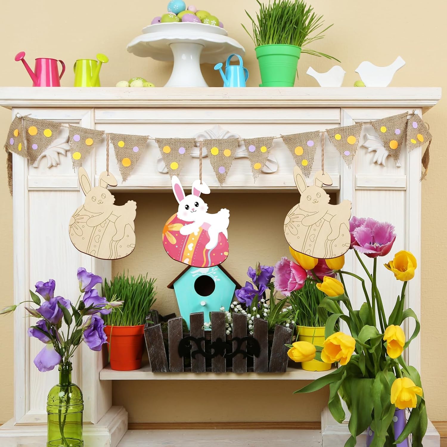 Decorative Easter mantel with bunting, birdhouse, and flowers on a fireplace.