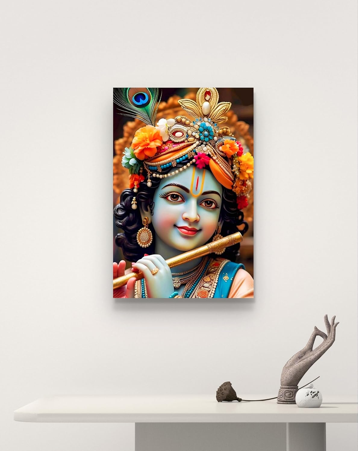 Canvas print of a deity with a colorful headdress on a white wall.