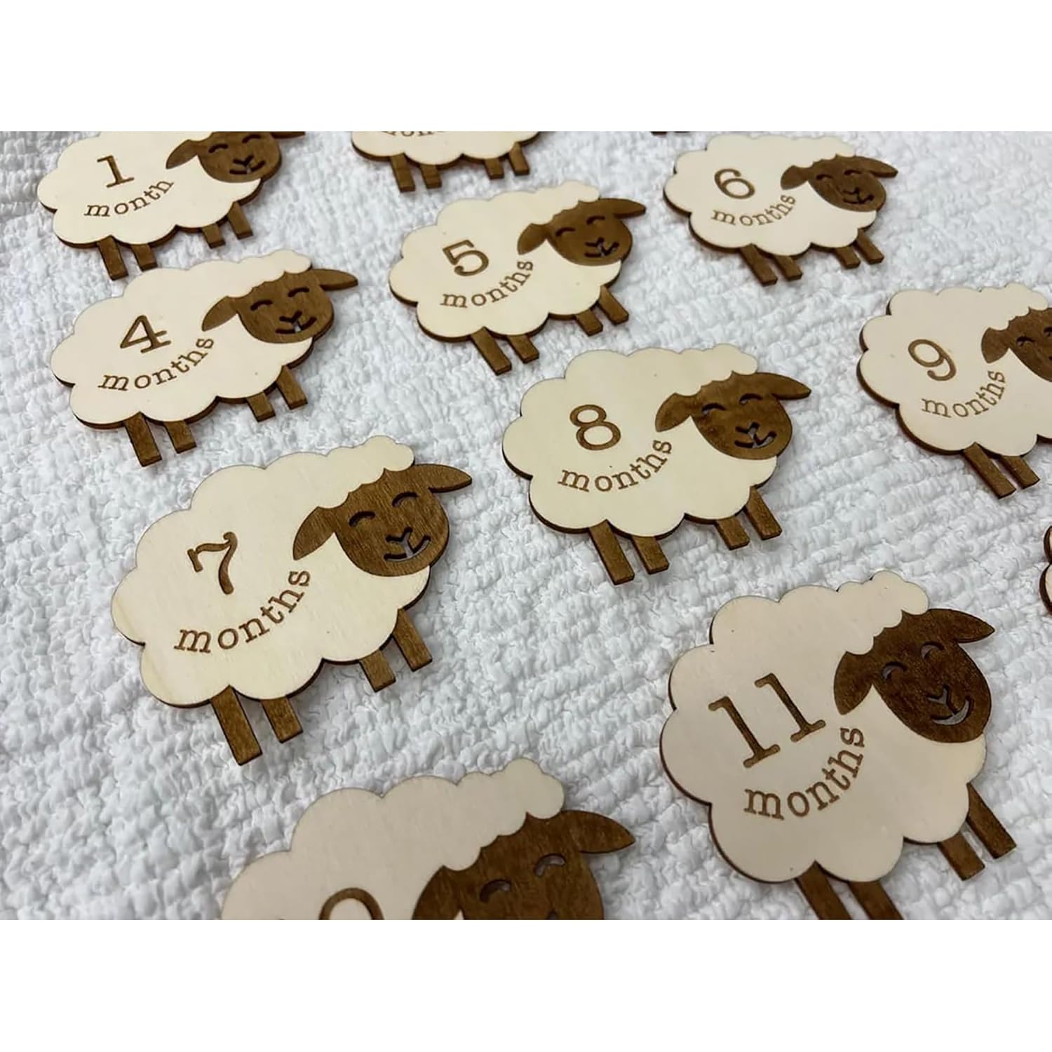 Sheep-shaped milestone markers with numbers on a textured surface