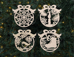 Four decorative Christmas ornaments on a green pine branch with lights.