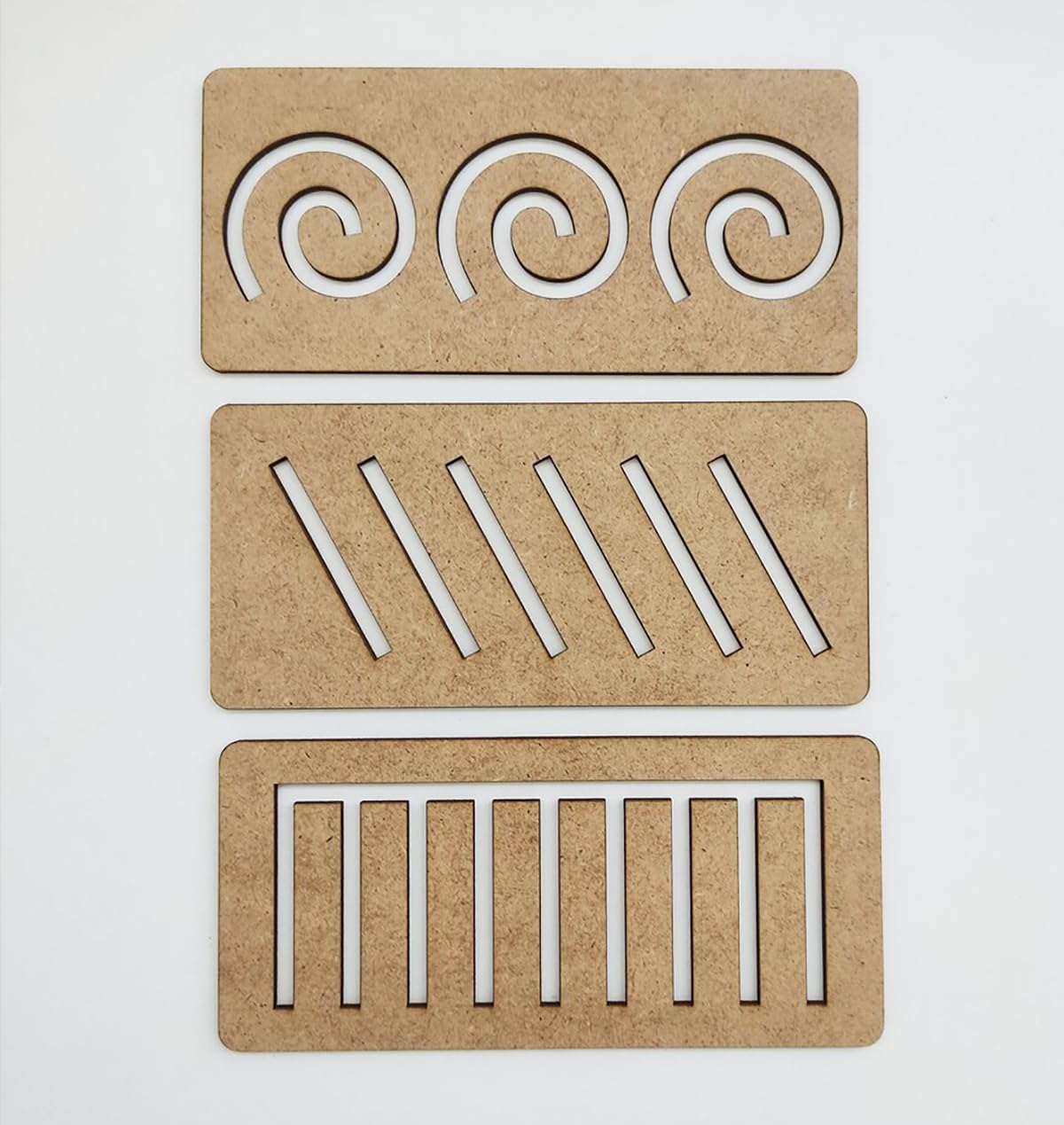 Three wooden coasters with cut-out patterns on a white background
