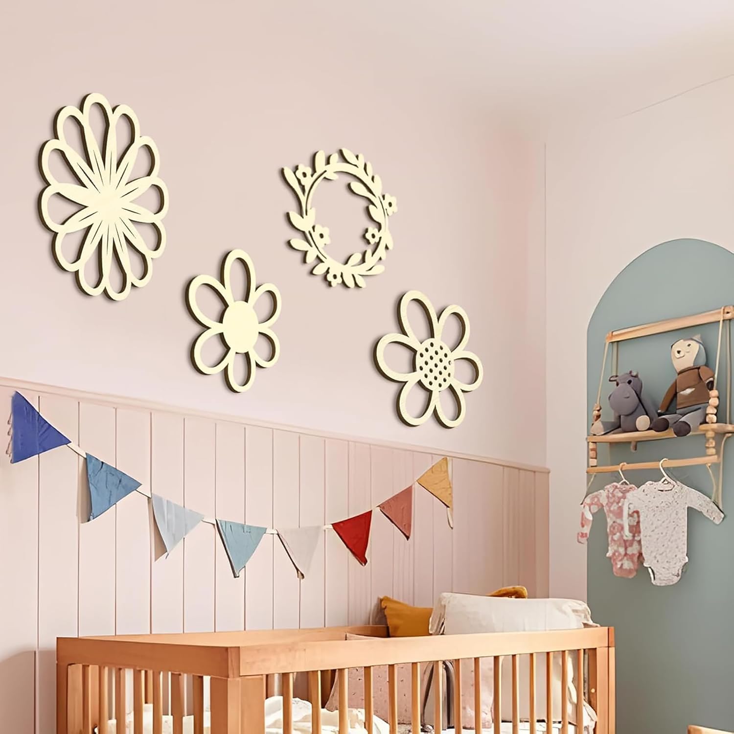 Nursery room with wooden crib, decorative wall art, and colorful flags.