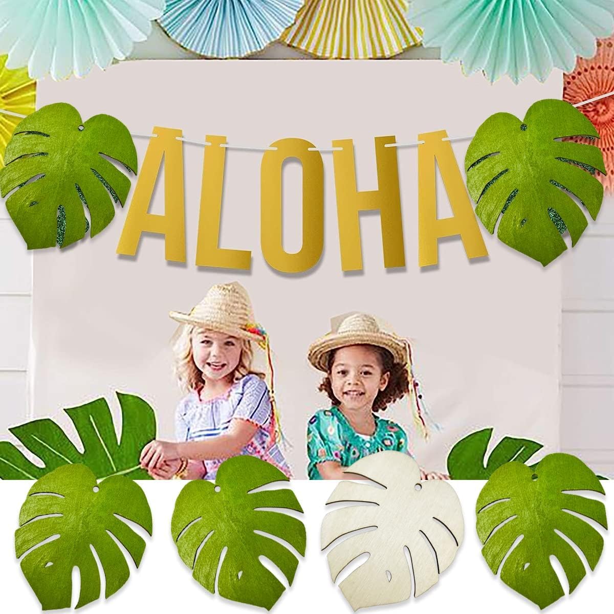 Tropical-themed party decorations with 'ALOHA' banner, palm leaves, and children in hats.