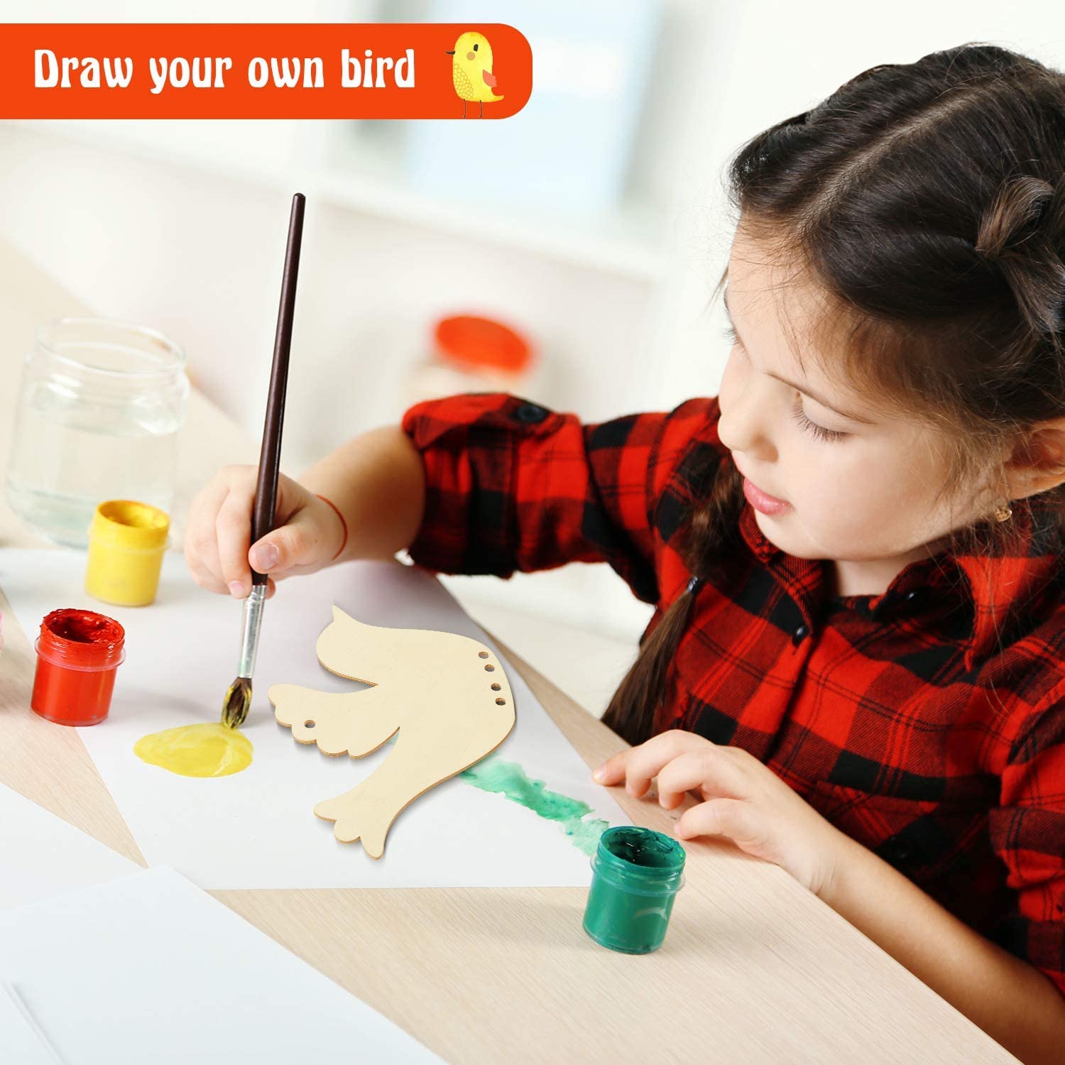Child painting a wooden bird with colorful paint on a table.