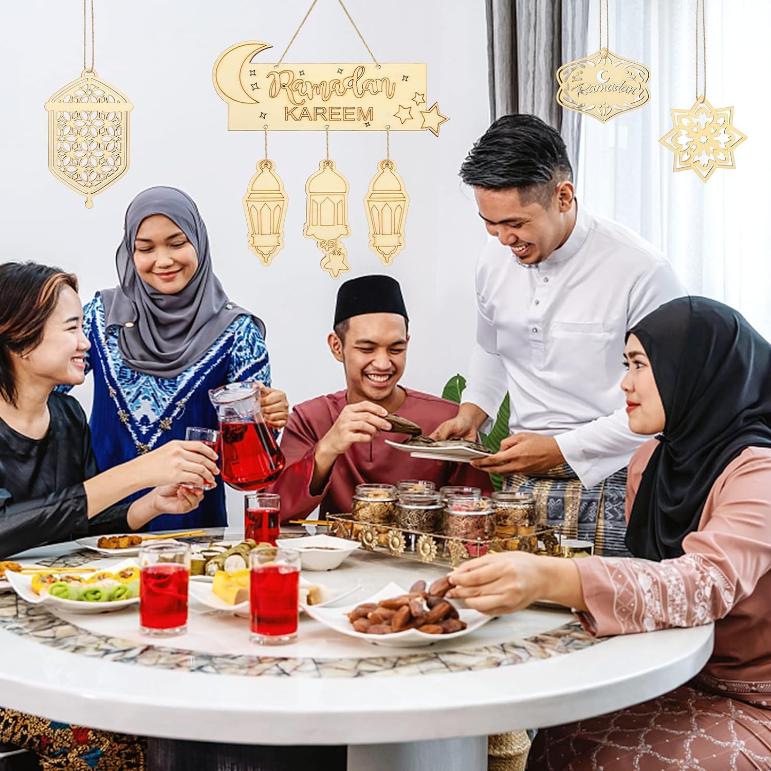 Group of people enjoying a meal together with 'Ramadan Kareem' decorations.