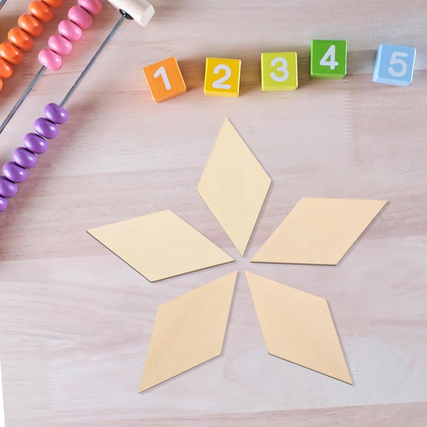 Colorful number blocks and an abacus on a wooden surface with geometric shapes.