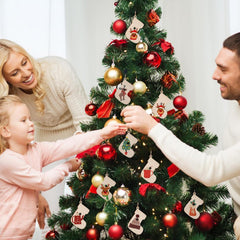Family decorating a Christmas tree with ornaments.