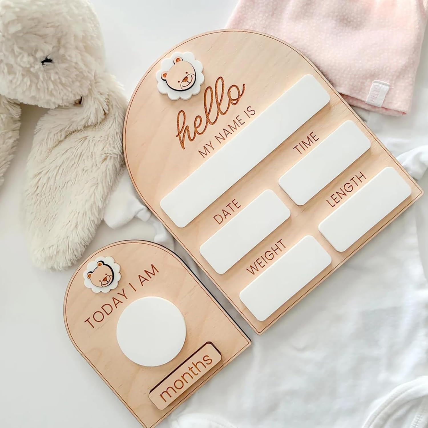 Baby growth chart with heart shape on a soft surface with a plush toy.