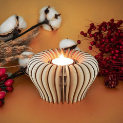 Wooden candle holder with a lit candle surrounded by cotton and berries on an orange background