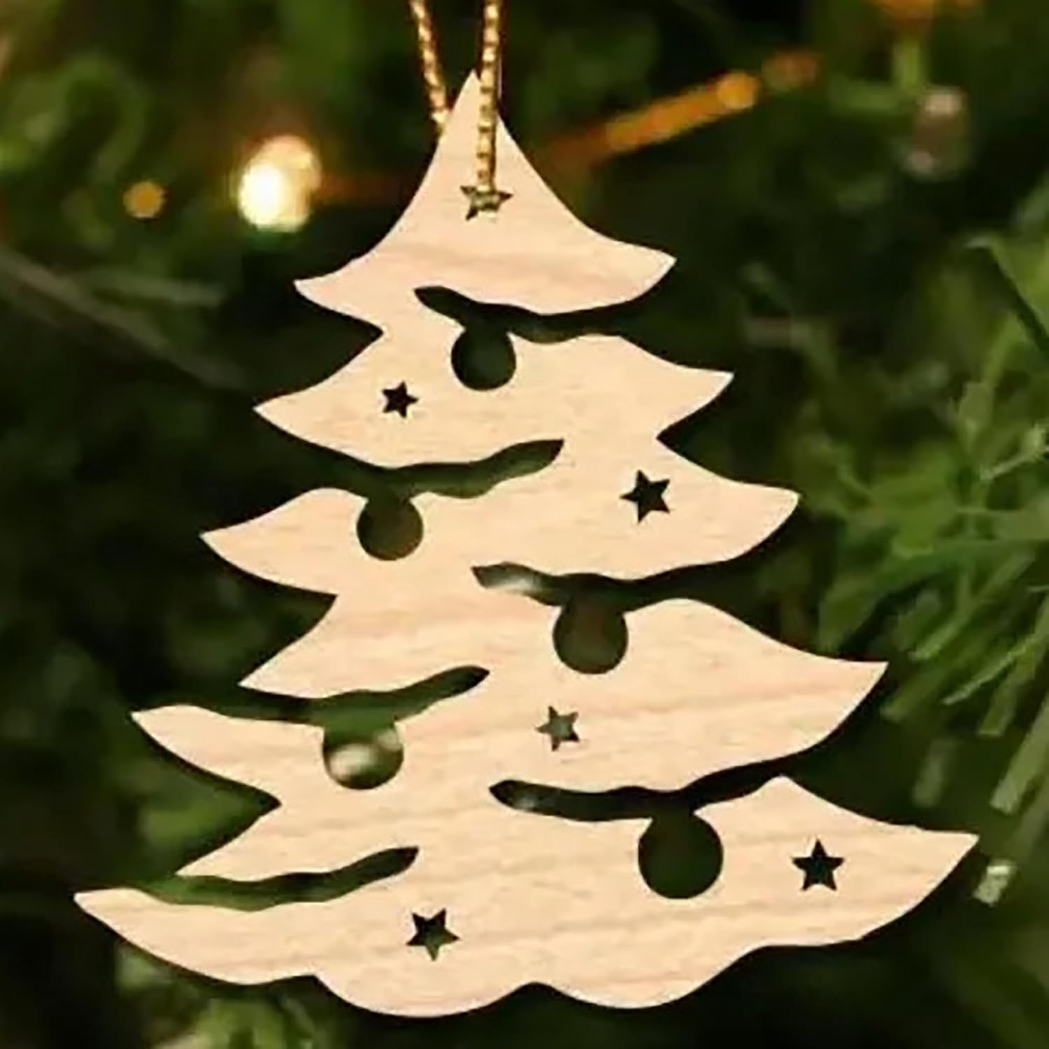 Wooden Christmas tree ornament with stars on a green background