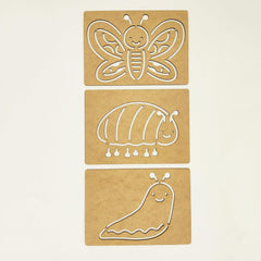 Three cardboard cutouts of a butterfly,茧, and caterpillar on a beige background