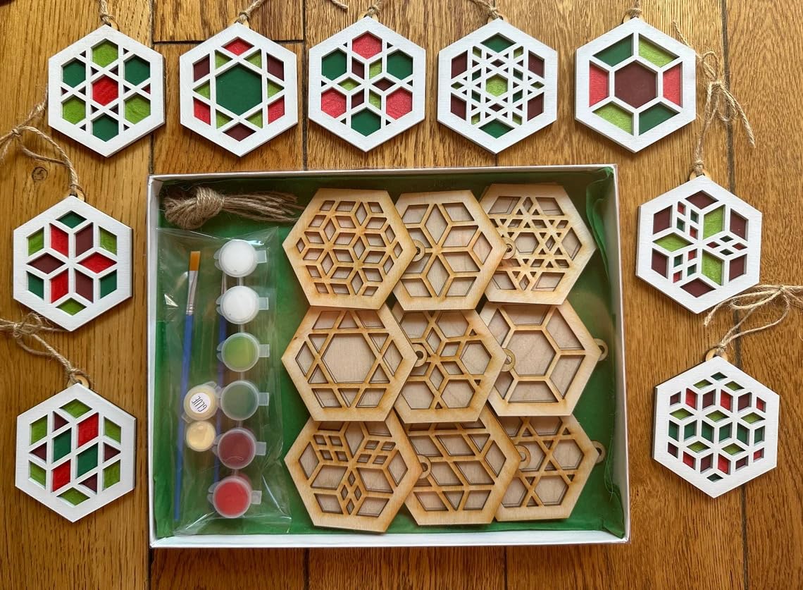 Wooden geometric shapes with paint supplies on a wooden surface