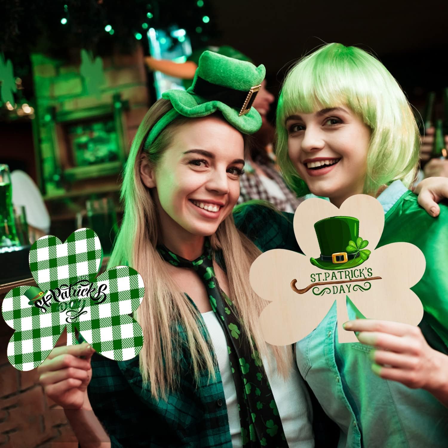 Two people celebrating St. Patrick's Day with decorative signs.