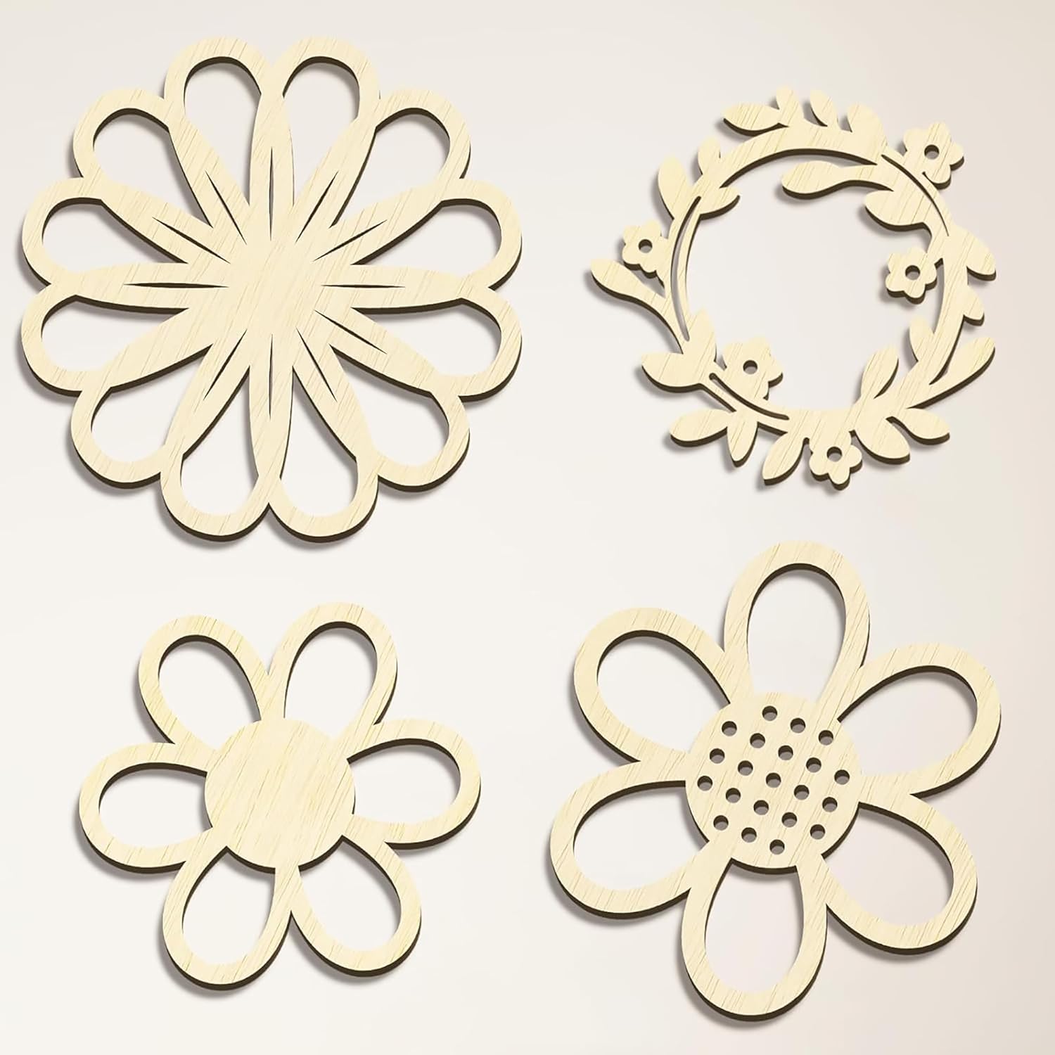 Four wooden floral cutouts on a beige background