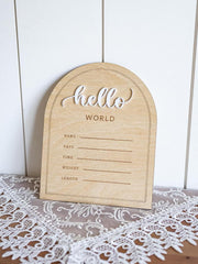 Wooden baby登记板 with 'hello world' text on a lace surface