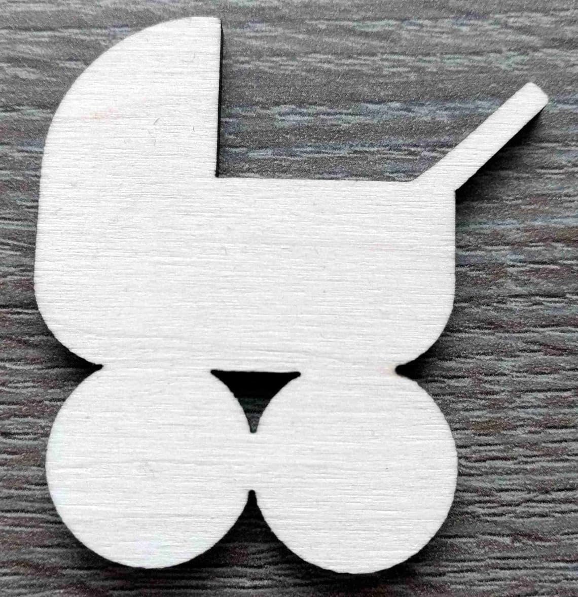 White butterfly-shaped object on a wooden surface