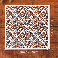 Decorative metal screen with intricate floral pattern on a wooden background