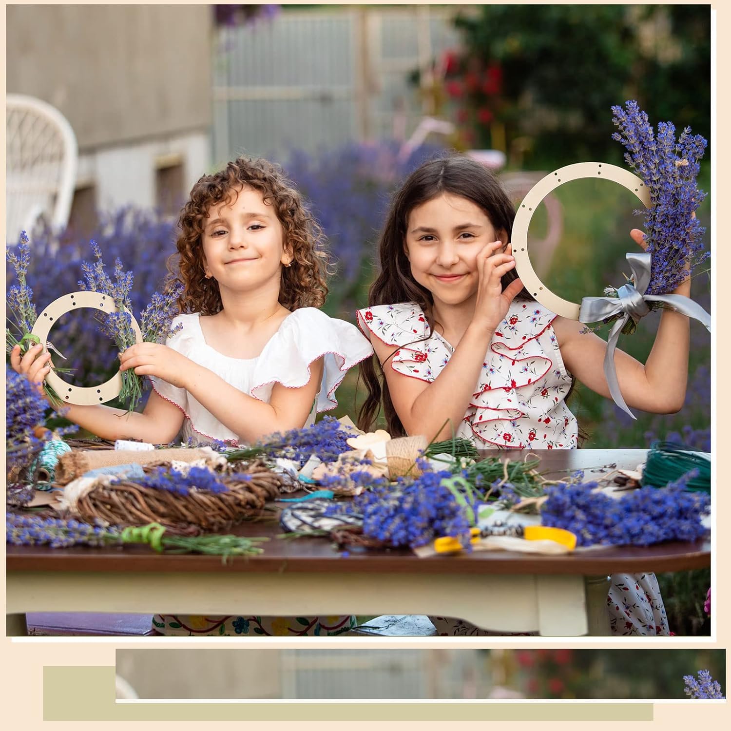 Two young girls making wreaths with lavender and other materials outdoors.