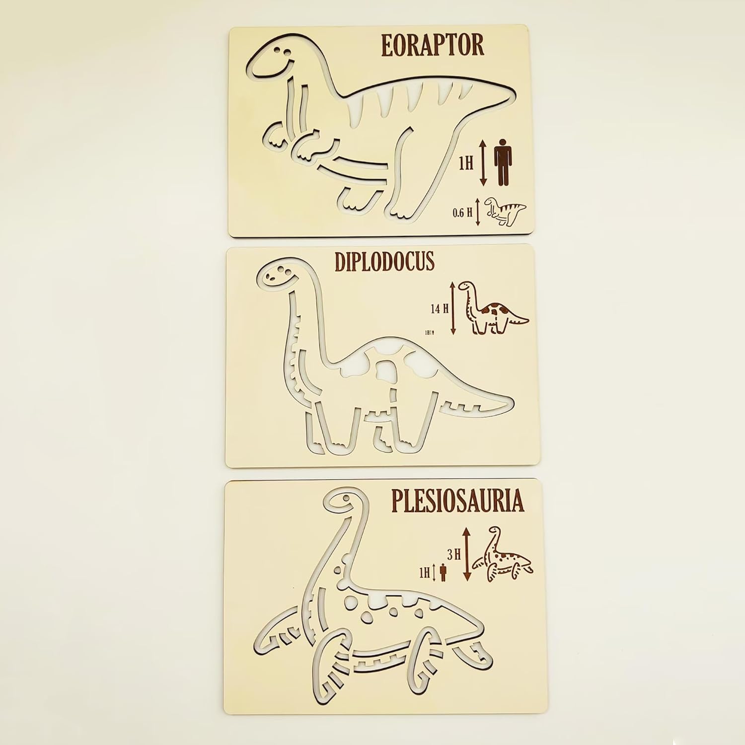 Three dinosaur-themed wooden stamps on a beige background