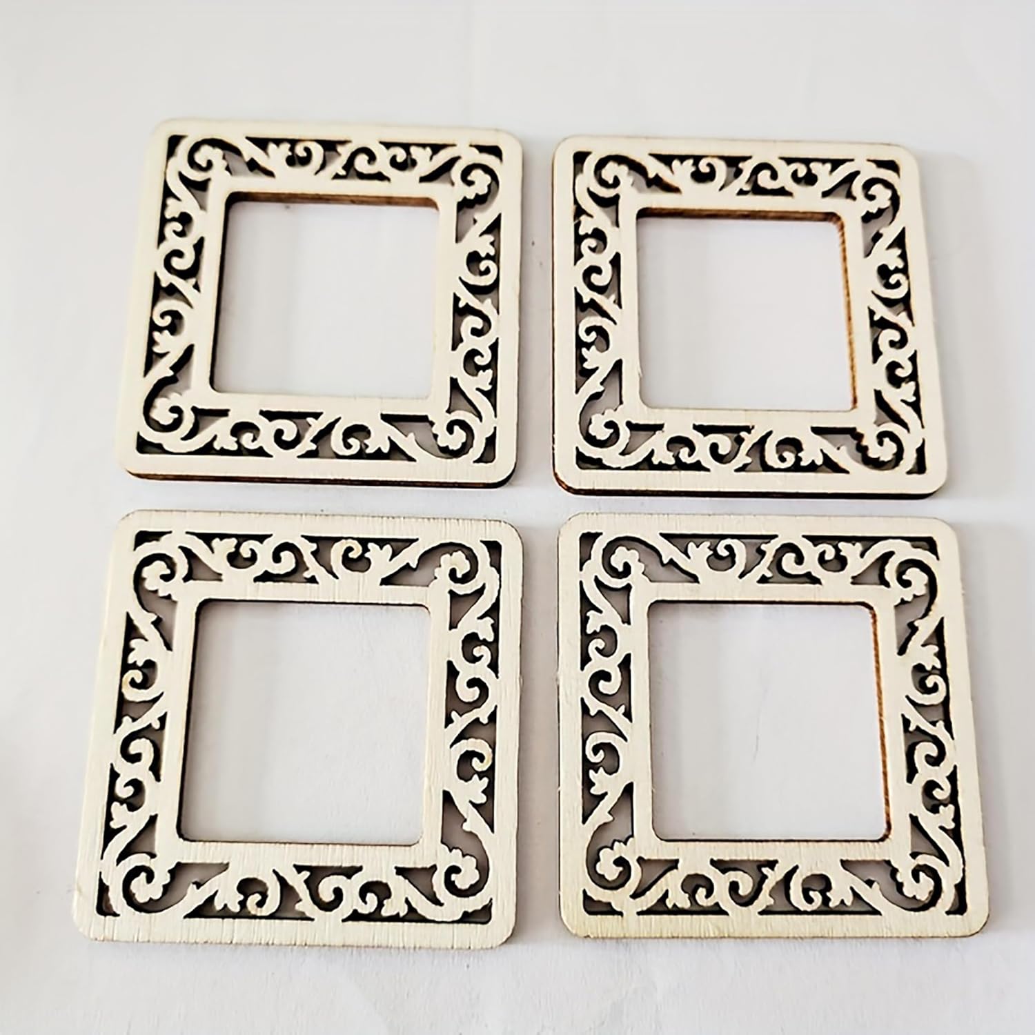 Four decorative square frames with intricate patterns on a light gray background