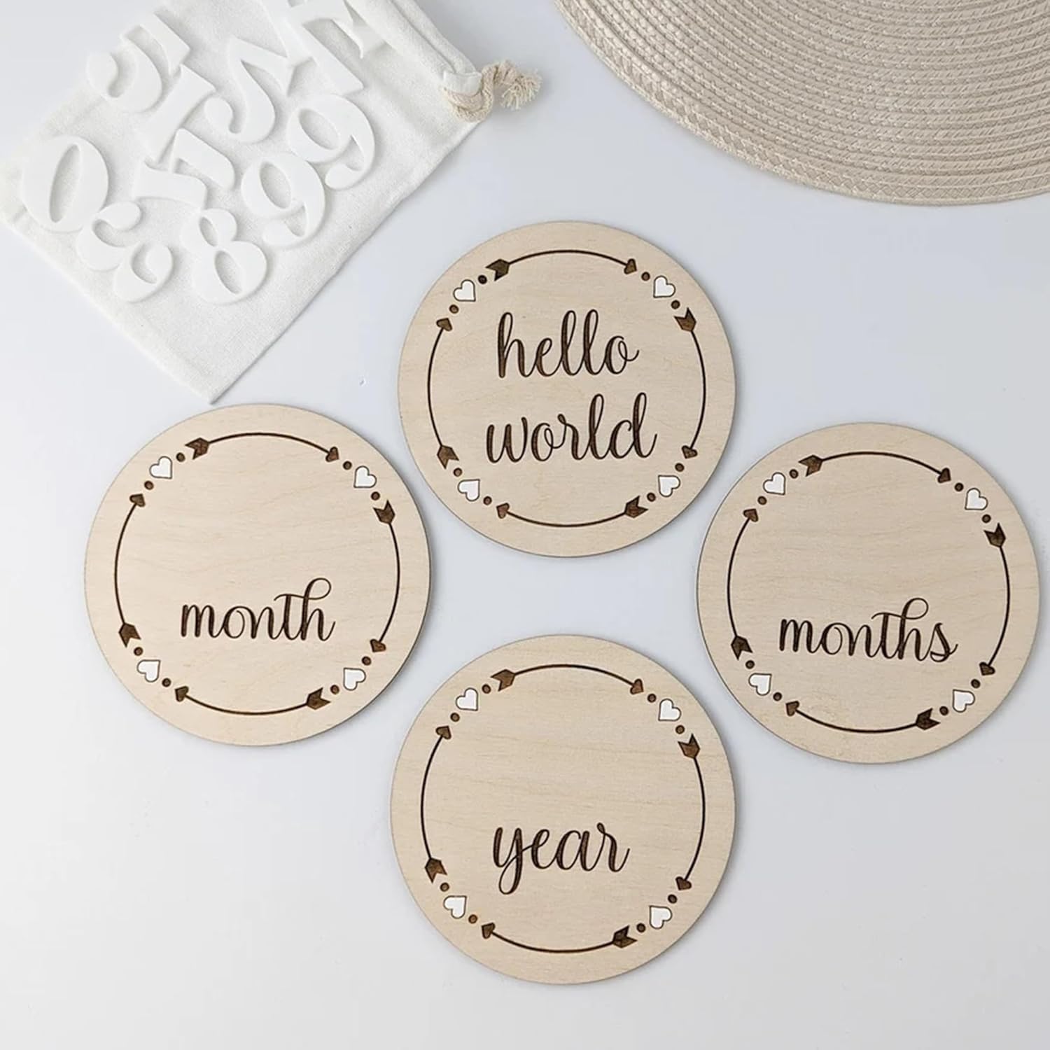 Four wooden discs with engraved text on a light background