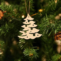 Wooden Christmas tree ornament hanging on a green tree with pine cones.