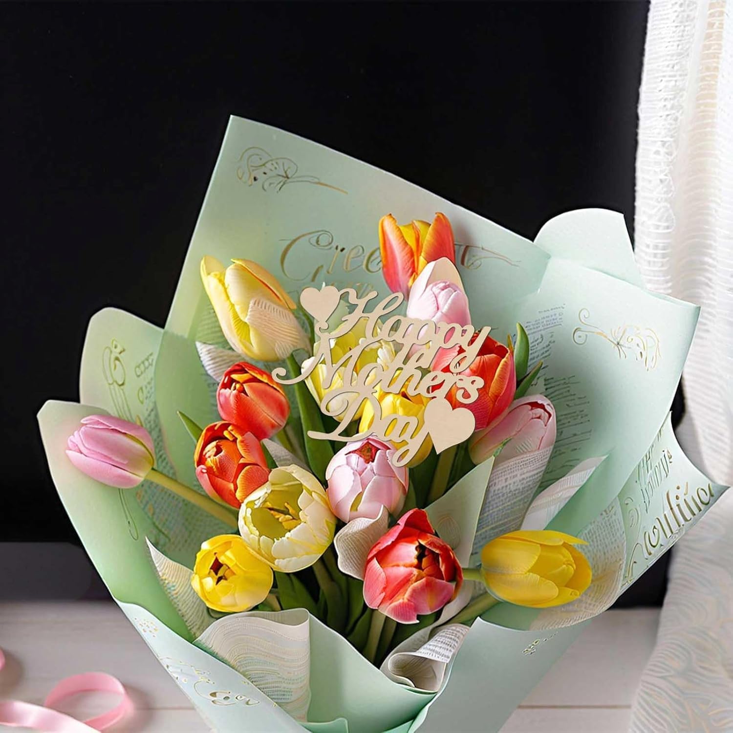 Bouquet of tulips with a 'Happy Mother's Day' card on a dark background