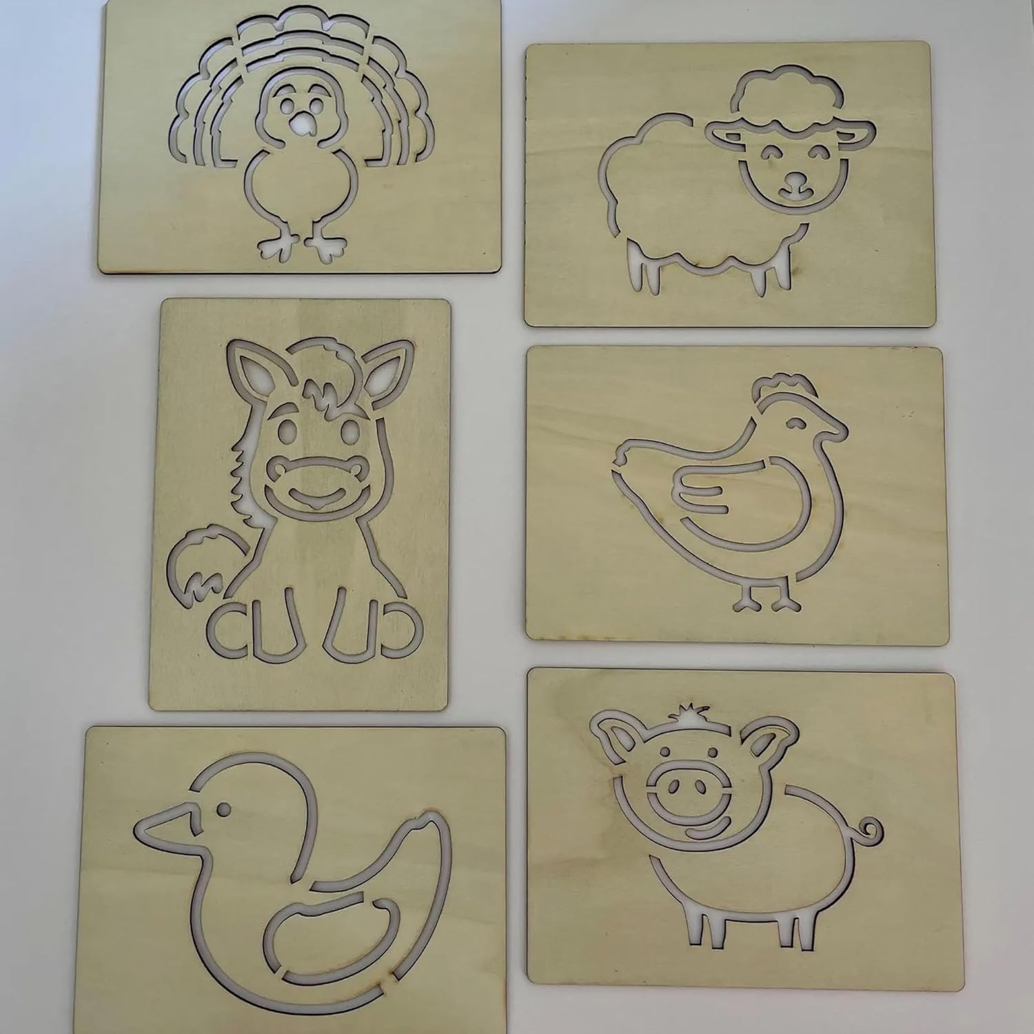 Set of six wooden animal stamps on a white background