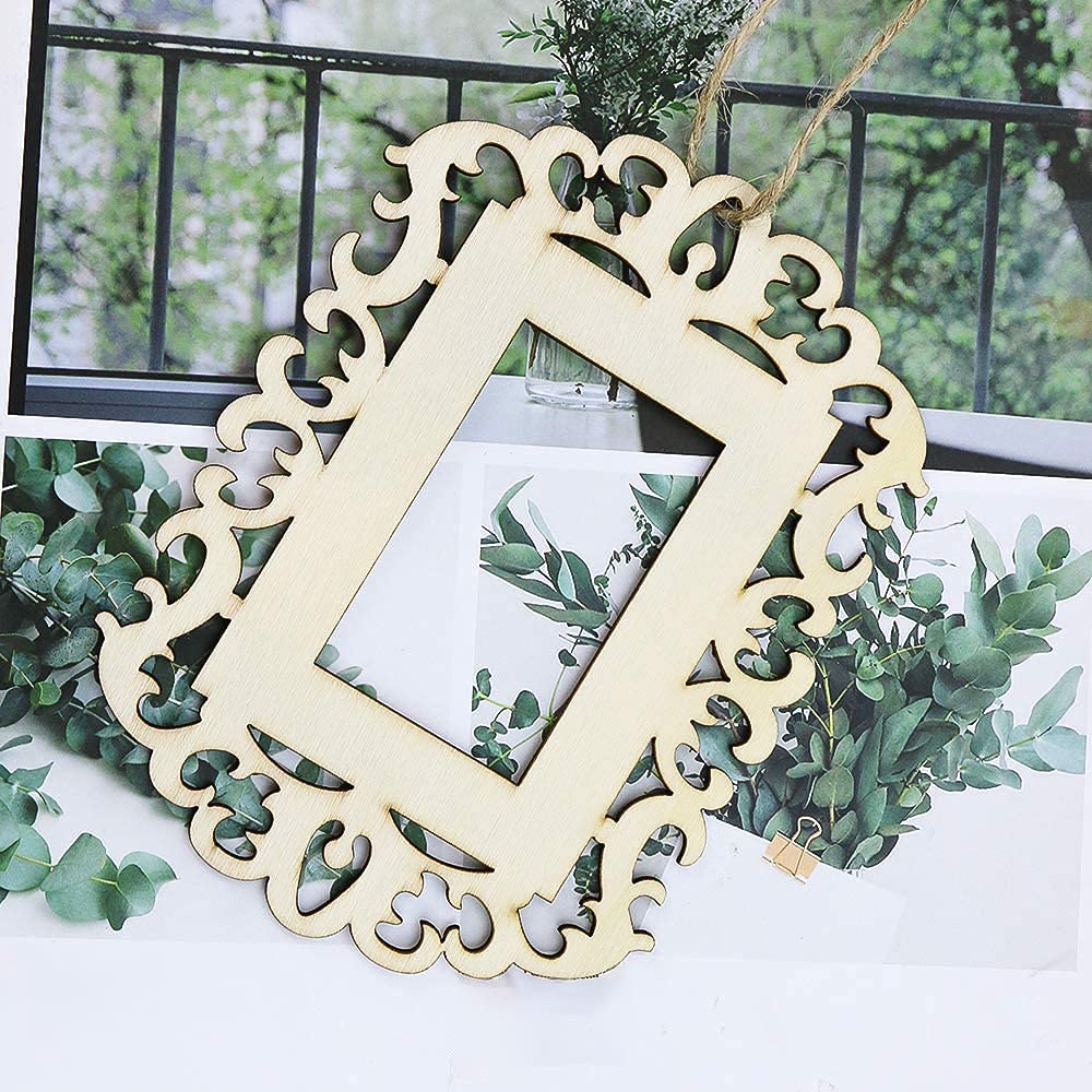 Decorative wooden frame with intricate cut-out patterns hanging on a wall with greenery.