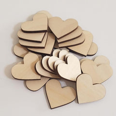 Stack of wooden heart shapes on a light gray background